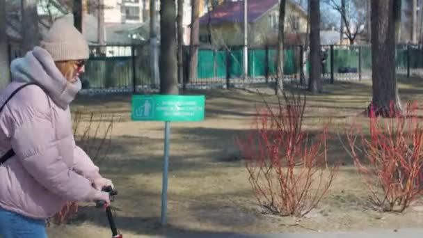 年轻女子骑着踢踏板车 — 图库视频影像