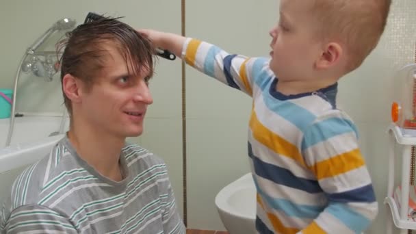 Son Combing Father — Stock Video