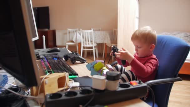 Little Boy Playing On Computer With Joystick — Stockvideo