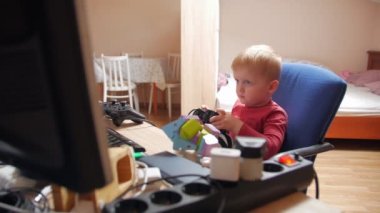 Little Boy Playing Computer Game With Joystick