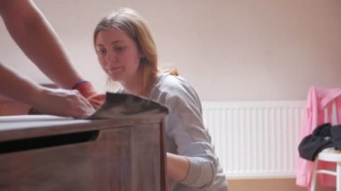Polishes Furniture With Sandpaper