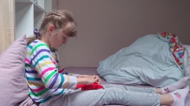 Menina com brinquedo anti-stress na cama — Vídeo de Stock