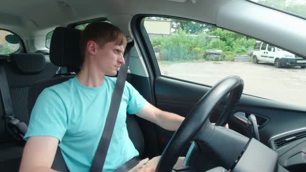 Hombre en coche mira alrededor de cámara lenta — Vídeos de Stock