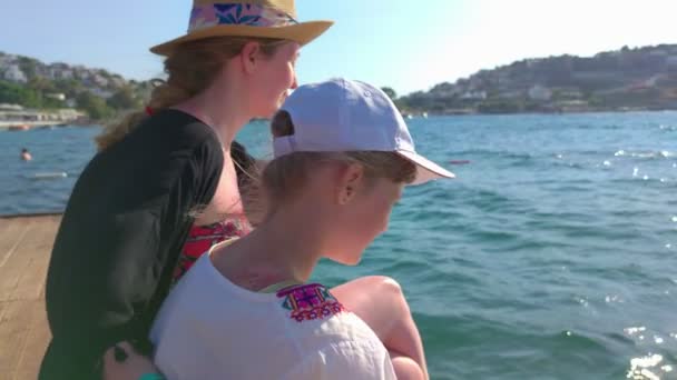 Mother With Girl Sitting On The Pier — Stock Video