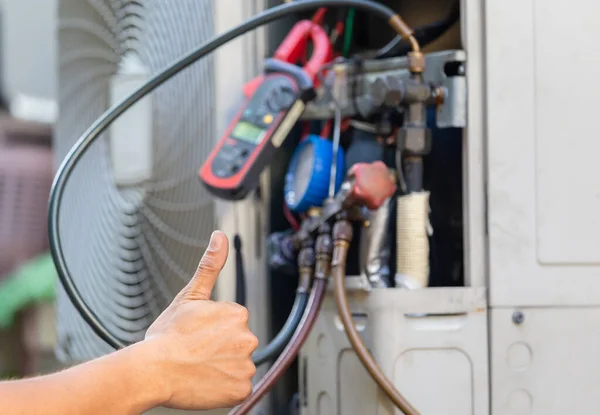 Air Conditioning Repair man hands checking and fixing modern air conditioning system, Technician team checking leakage air conditioning system