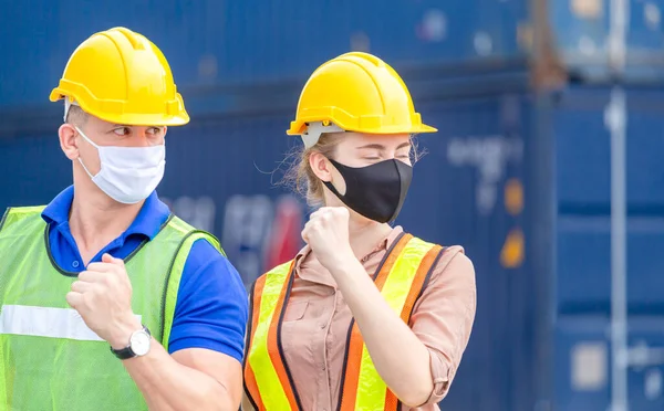 Engineer and worker team wearing protection face mask against coronavirus, Business people team celebration at cargo containers