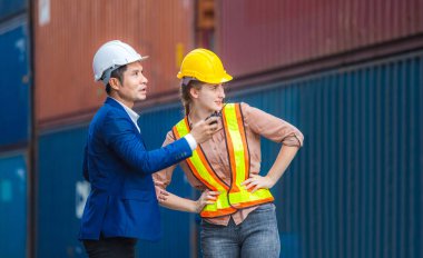 Mühendis ve ustabaşı işçi takımı konteynırları kargo, lojistik ve takım çalışması konseptinden kontrol ediyor.