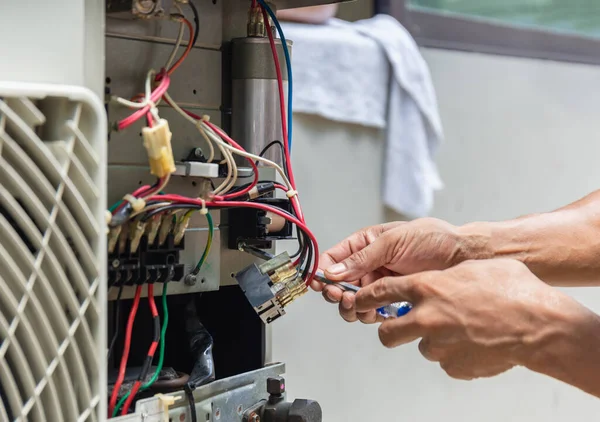 Close up of Air Conditioning Repair, repairman installing magnetic contactor and fixing air conditioning system