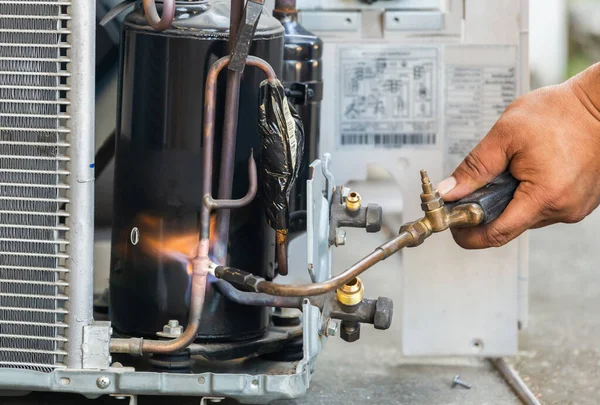 Close up of Air Conditioning Repair use fuel gases and oxygen to weld or cut metals, Oxy-fuel welding and oxy-fuel cutting processes, repairman on the floor fixing air conditioning system