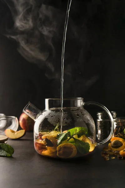 selective focus, a teapot of tea with fruits