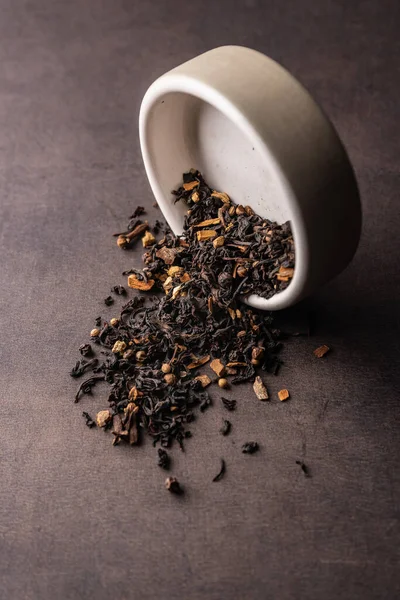 selective focus, natural black leaf tea in a clay bowl
