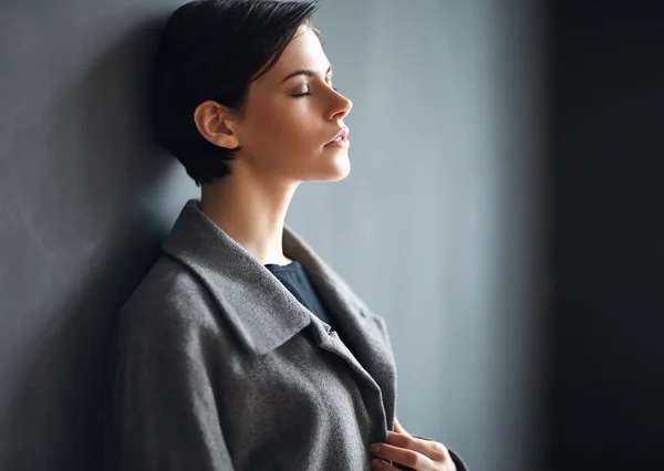 Müde Frau auf dunklem Hintergrund — Stockfoto