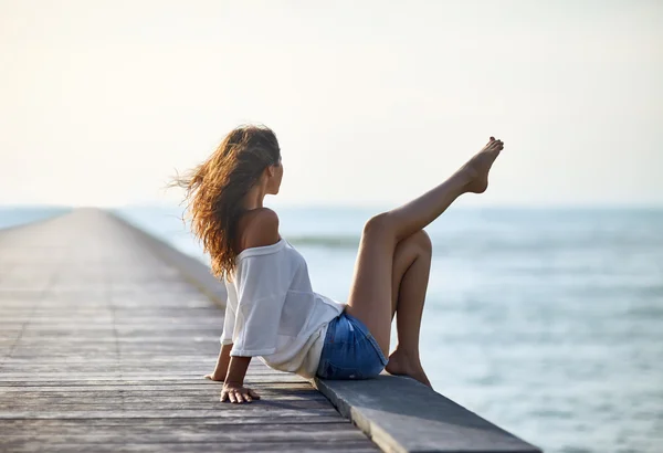 Sexy beautiful woman relaxing on pier — Stock Photo, Image