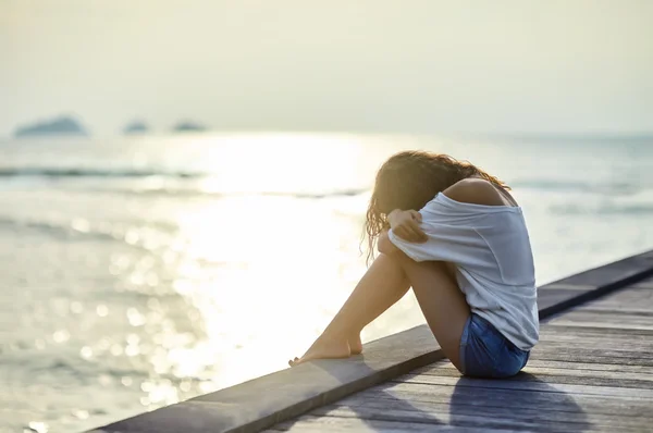 Droevige, eenzame mooie vrouw op pier — Stockfoto