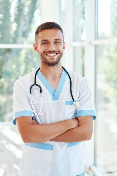 Porträtt av självsäker leende manlig läkare med stetoskop i medicinsk uniform — Stockfoto