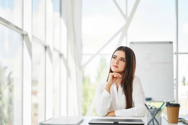 Confiante mulher de negócios bonita em um escritório moderno brilhante olhando para copiar espaço — Fotografia de Stock