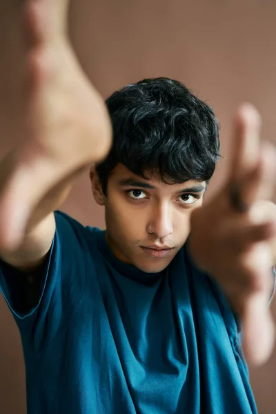 Attractive stylish young man reaching out hands to the camera — Stock Photo, Image
