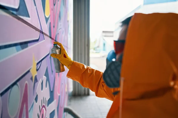 Straatkunstenaar die kleurrijke graffiti op de muur schildert — Stockfoto