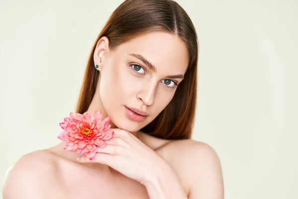 Close up portret pięknej młodej kobiety z kwiatem na tle studio — Zdjęcie stockowe