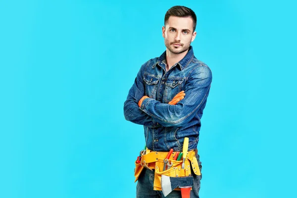 Retrato de trabalhador de construção masculino bonito confiante com braços cruzados e espaço de cópia — Fotografia de Stock