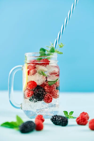Fresh berries cocktail in glass jar