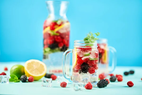 Fresh berries cocktail in glass jar