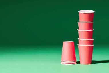 Yeşil arkaplanda, kopyalama alanı olan kırmızı kağıt bardaklar