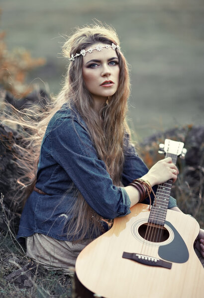 Beautiful hippie girl with guitar