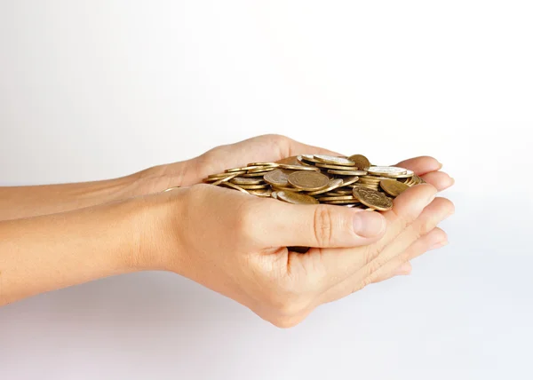 Monedas en palma de manos — Foto de Stock