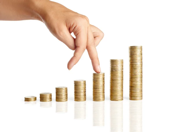 Hand and stacks of coins — Stockfoto