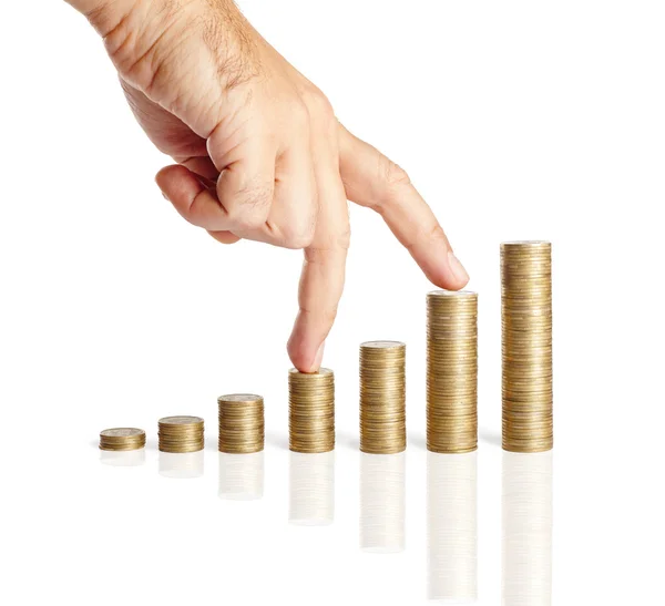 Hand and stacks of coins — Stock Photo, Image