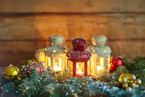 Lanterns, baubles and fir in snow — Stock Photo, Image