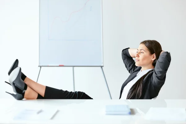 Relaxed business woman in the office — Stock Photo, Image