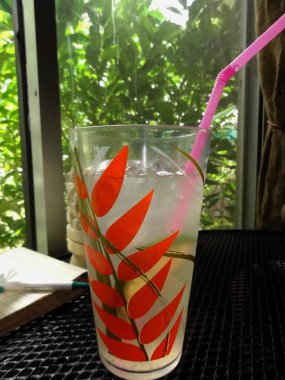 Uzun boyalı bir bardakta limon içmek, pencerenin yakınına yerleştirilmek.