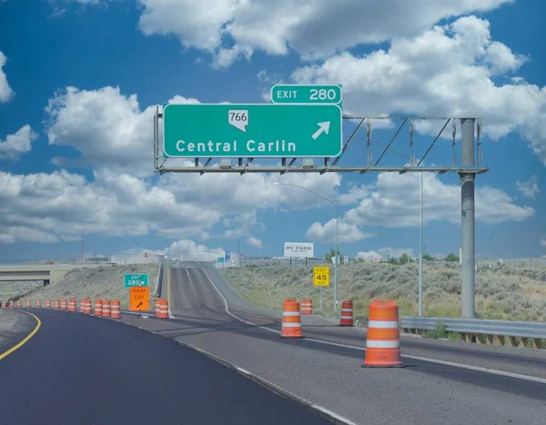 Directional signs at Interstate 80 with an arrow to Central Carlin, Nevada.