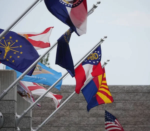 Flags of different states flying from poles at Mt Rushmore National Monument, South Dakota.