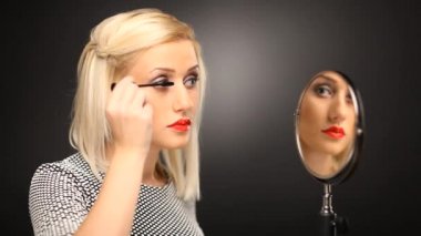 sarışın model maskara ayna üzerine koyarak
