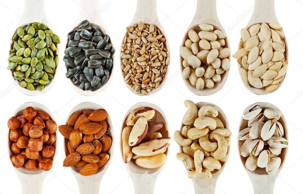 Peanuts, cashews, hazelnuts, almonds, Brazil nuts, sunflower seeds, pumpkin seeds, pistachios close up. Nuts in a wooden spoon isolated on a white background.