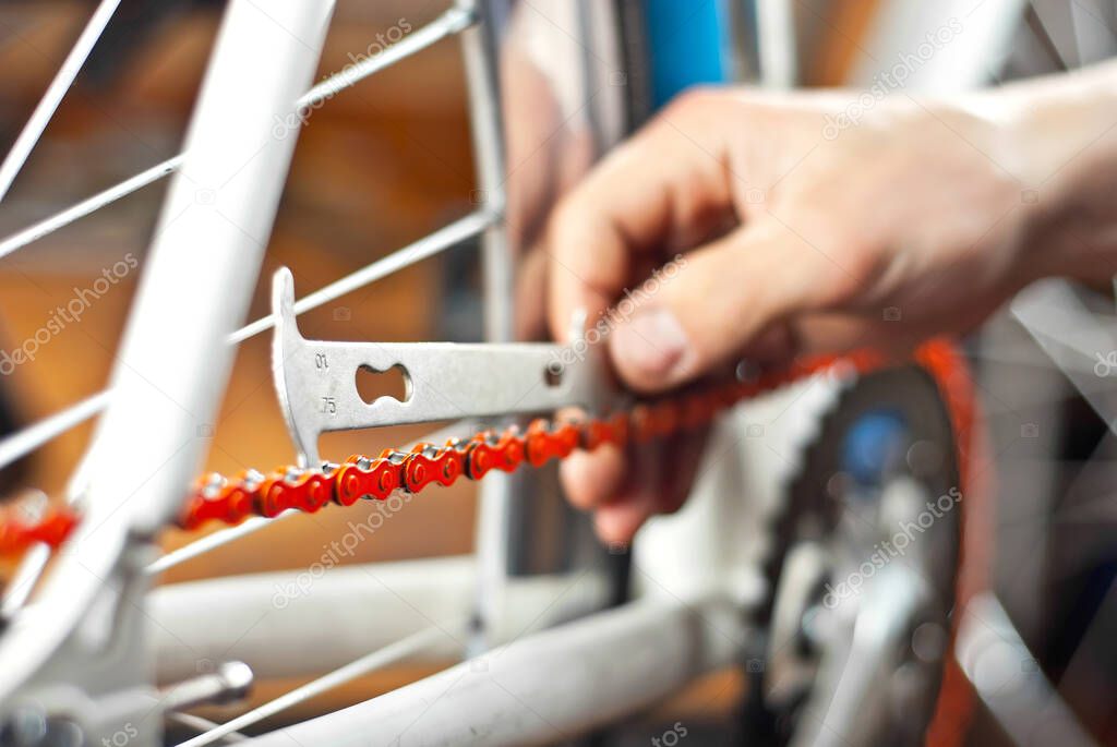 Bicycle chain close up. Bicycle maintenance and service. A tool for measuring bicycle chain wear.
