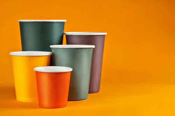 Disposable Paper Cups Orange Background Glasses Different Sizes Colors Close — Stock Photo, Image