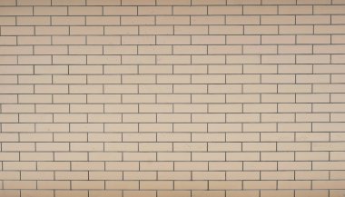 Tuğla duvar dokusu. Sergilerde duvar veya çit örnekleri sunuluyor. Sarı tuğla. Yakın çekim..