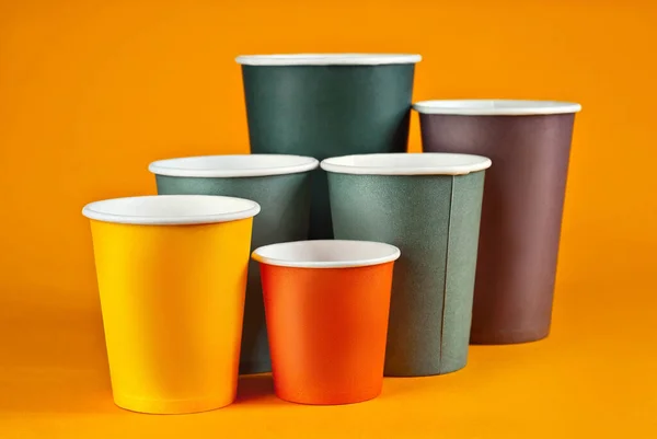 Disposable Paper Cups Orange Background Glasses Different Sizes Colors Close — Stock Photo, Image