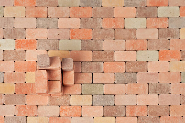 Colorful bricks on a pile. Brick texture close up. The blocks are stacked on brick paving. Copy space and free space near the brick.