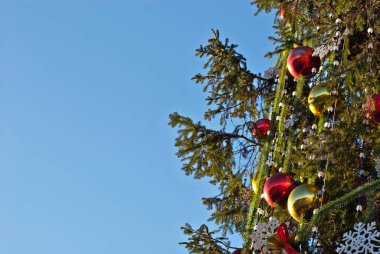 Geleneksel Noel süsleri Noel ağacında. Çok renkli çelenkler ve oyuncaklar kapanıyor.