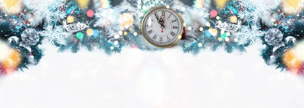 Clock and Silver Christmas cones on the Christmas tree. Bokeh and glare. Christmas banner. Background. copy space.