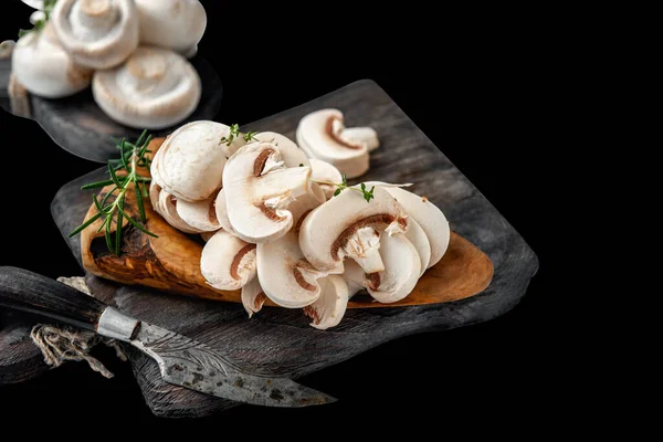 natural, organic mushrooms on a vintage wooden table. Sliced Slices Of Fresh Raw Mushrooms Porcini Mushrooms On A Wooden Cutting Board, Isolated On A White Background, Side View.