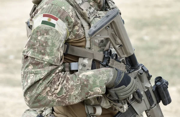 アサルトライフルと軍の制服にクルディスタンの旗を持つ兵士 コラージュ — ストック写真