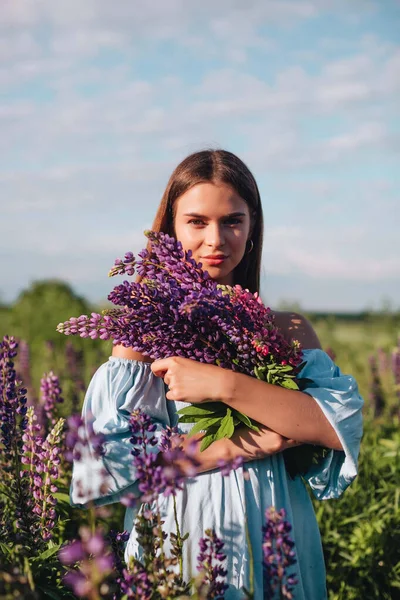 Beautiful Girl Long Hair Blue Dress Holds Bouquet Lupines Field — Stock Photo, Image