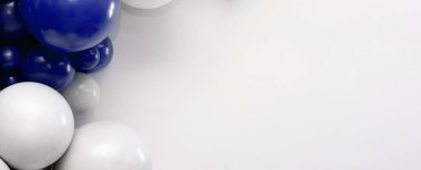 Temiz beyaz arka planda mavi ve beyaz balon çelengi, kutlama, parti ve etkinlik tasarımı için ideal dekoratif zemin.