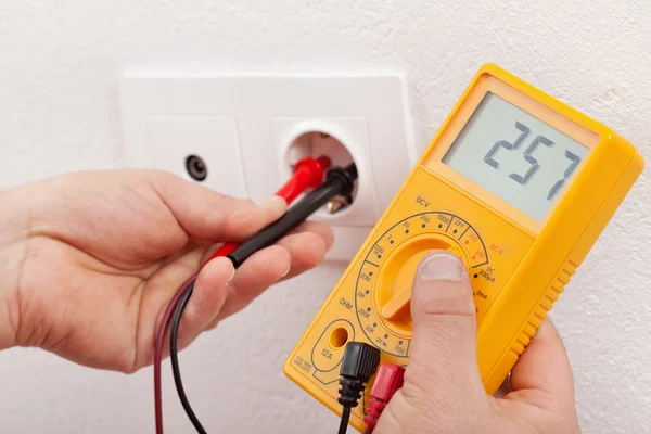 Checking voltage in a wall fixture — Stock Photo, Image
